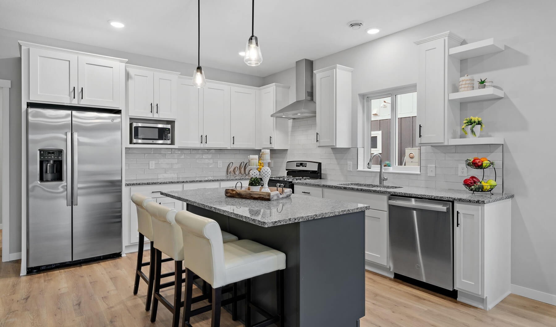 Townhome kitchen with granite countertops and white cabinets at The Preserve at Stone Gate