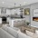 Open living room with electric fireplace and kitchen with peninsula 